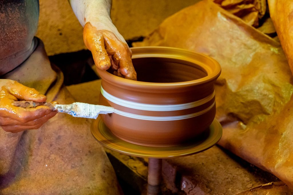 artisan-crafting-pottery-on-a-spinning-wheel-34259447