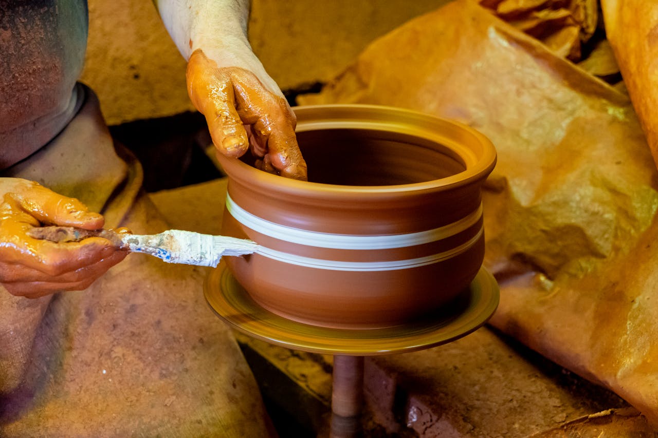 artisan-crafting-pottery-on-a-spinning-wheel-34259447